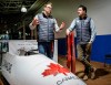 Bobsleigh Canada head Jesse Lumsden, left, and Luge Canada head Sam Edney pose with the tools of their sport in Calgary, Tuesday, Oct. 29, 2024. THE CANADIAN PRESS/Jeff McIntosh