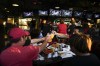Supporters of former President Donald Trump drink beers as they watch him speak on television on July 18, 2024. As Americans head to the polls for a presidential election Tuesday, their compatriots and Canadian neighbours north of the border will be watching the results. (AP Photo/Ashley Landis)