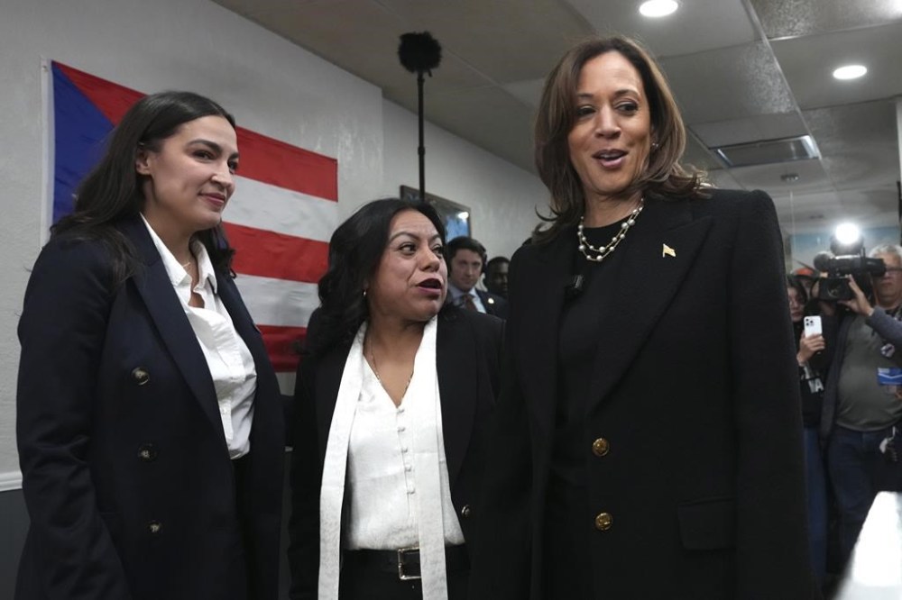 Democratic presidential nominee Vice President Kamala Harris, from right, visits Old San Juan Cafe restaurant with restaurant owner Diana de La Rosa and Rep. Alexandria Ocasio-Cortez, D-N.Y., during a campaign stop in Reading, Pa., Monday, Nov. 4, 2024. (AP Photo/Jacquelyn Martin)