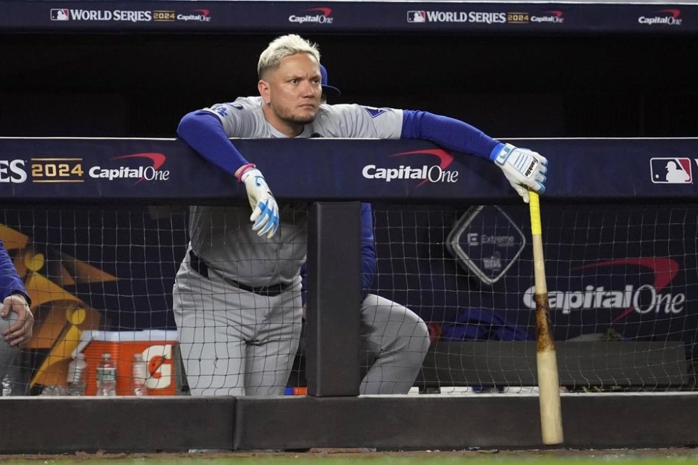 Los Angeles Dodgers' Miguel Rojas watches from the dugout during the eighth inning in Game 4 of the baseball World Series against the New York Yankees, Tuesday, Oct. 29, 2024, in New York. (AP Photo/Godofredo A. Vásquez)