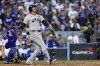 New York Yankees' Juan Soto, right, watches his home run along with Los Angeles Dodgers catcher Will Smith during the third inning in Game 2 of the baseball World Series, Saturday, Oct. 26, 2024, in Los Angeles. (AP Photo/Godofredo A. Vásquez)