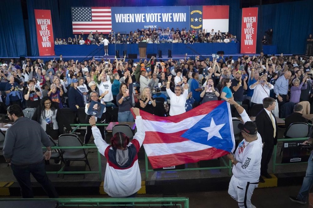 Supporters carry the Puerto Rican flag before Democratic presidential nominee Vice President Kamala Harris arrives to speak at a campaign rally, Wednesday, Oct. 30, 2024, in Raleigh, N.C. (AP Photo/Allison Joyce)
