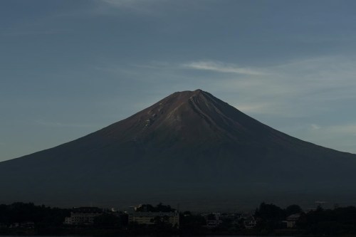 FILE - Mount Fuji in the early morning sunlight is seen from Lake Kawaguchi, Japan, on Aug. 7, 2019. (AP Photo/Jae C. Hong, File)