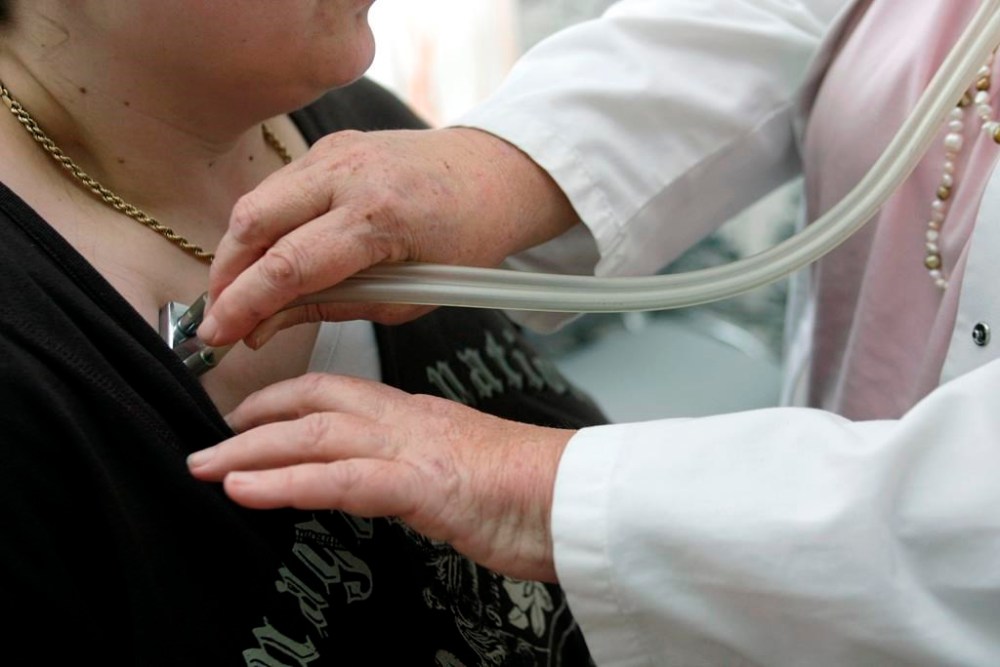 A doctor examines a patient with a stethoscope in her doctor's office in Stuttgart, Germany, April 28, 2008. The Saskatchewan Health Authority says people who consumed Domino's pizza products in Martensville last month may have been exposed to typhoid fever. THE CANADIAN PRESS/AP/Thomas Kienzle
