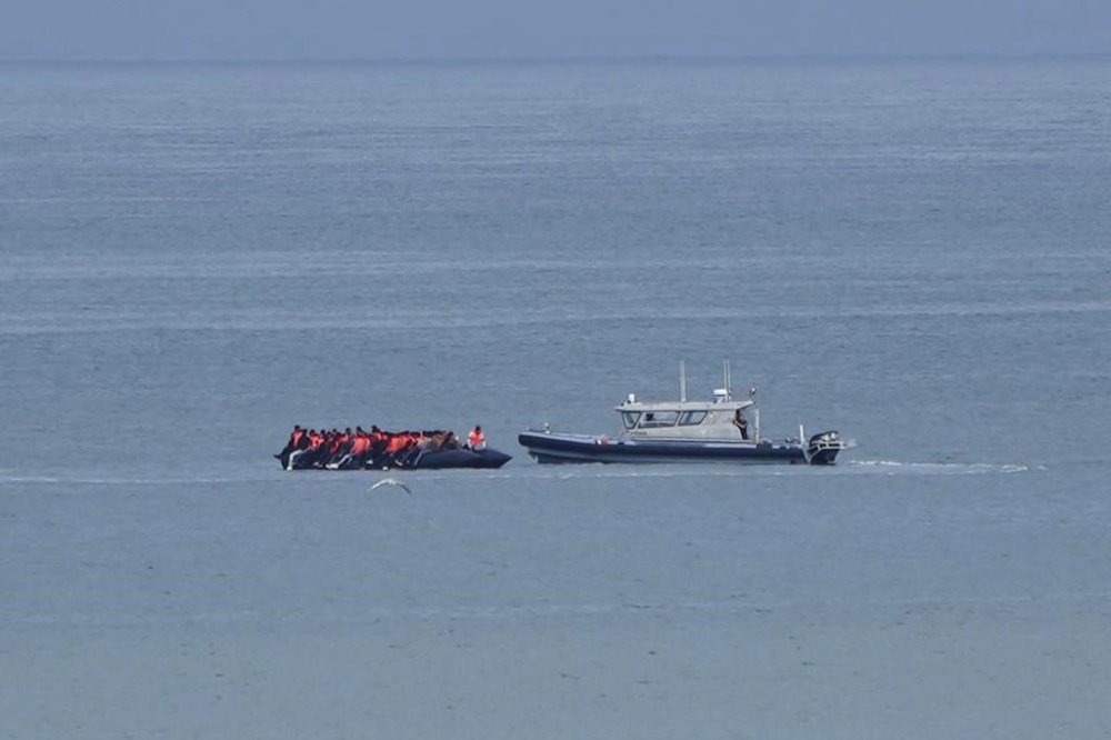 FILE - A boat thought to carry migrants is escorted by a vessel from the French Gendarmerie Nationale in the English Channel off Wimereux beach, France, Wednesday, Sept. 4, 2024. (AP Photo/Nicolas Garriga, File)