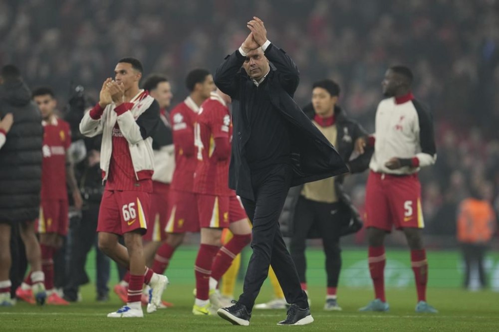 Liverpool's manager Arne Slot applauds the crowd at the end of the Champions League opening phase soccer match between Liverpool and Bayer Leverkusen at Anfield in Liverpool, England, Tuesday, Nov. 5, 2024. (AP Photo/Jon Super)