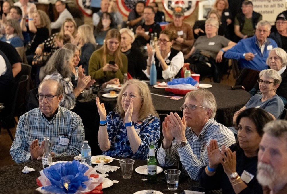 Viewers at the Democrats Abroad watch party in Toronto keep a close eye on U.S. election results on Tuesday, November 5, 2024. THE CANADIAN PRESS/Frank Gunn