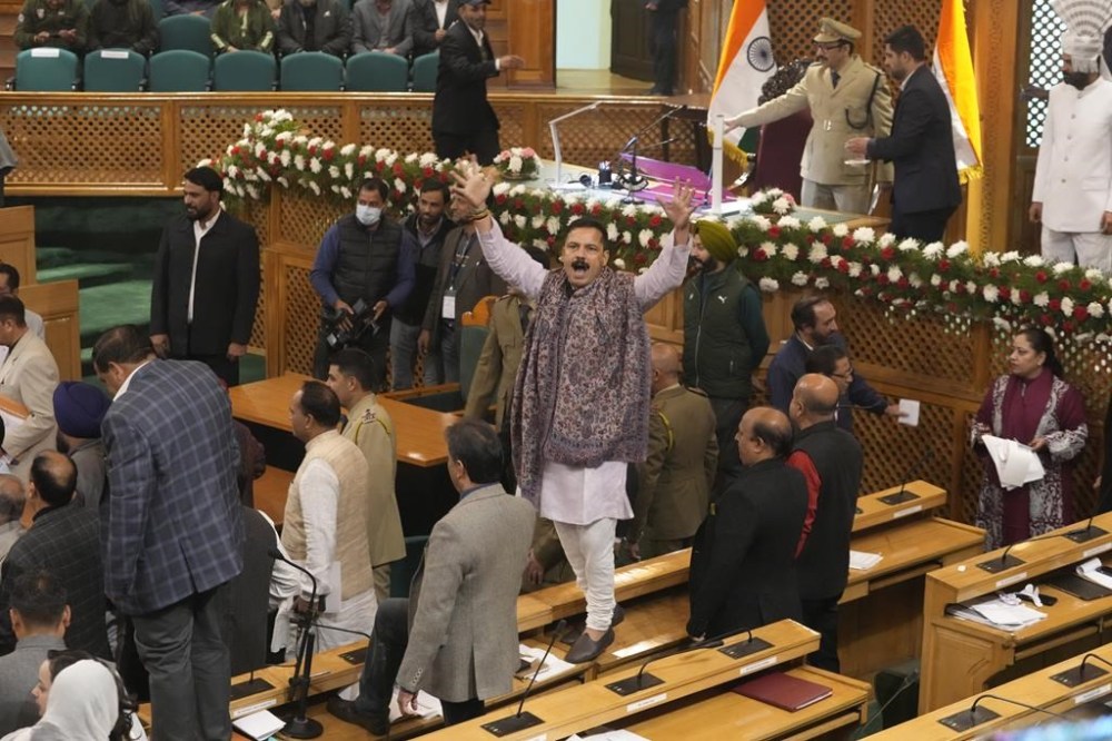 An Indian lawmaker, center, of Bharatiya Janata Party (BJP) protests inside the Jammu and Kashmir Assembly in Srinagar, Indian controlled Kashmir, Wednesday, Nov. 6, 2024, as the resolution was passed in the assembly to restore the special status of Jammu and Kashmir, which was revoked on Aug. 5, 2019. (AP Photo/Mukhtar Khan)