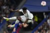 Real Madrid's Aurelien Tchouameni jumps for a header on top of Barcelona's Marc Casado during a Spanish La Liga soccer match between Real Madrid and Barcelona at the Santiago Bernabeu stadium in Madrid, Spain, Saturday, Oct. 26, 2024. (AP Photo/Manu Fernandez)