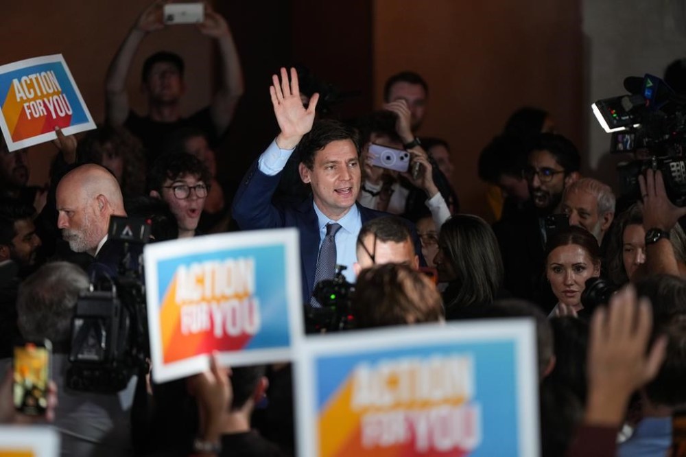 B.C. NDP Leader David Eby waves as he arrives to address supporters on election night in Vancouver, on Saturday, Oct. 19, 2024. British Columbia's new cabinet is set to be sworn in on Nov. 18, one month after the provincial election that gave Premier David Eby's NDP the slimmest of majorities, pending recounts. THE CANADIAN PRESS/Darryl Dyck