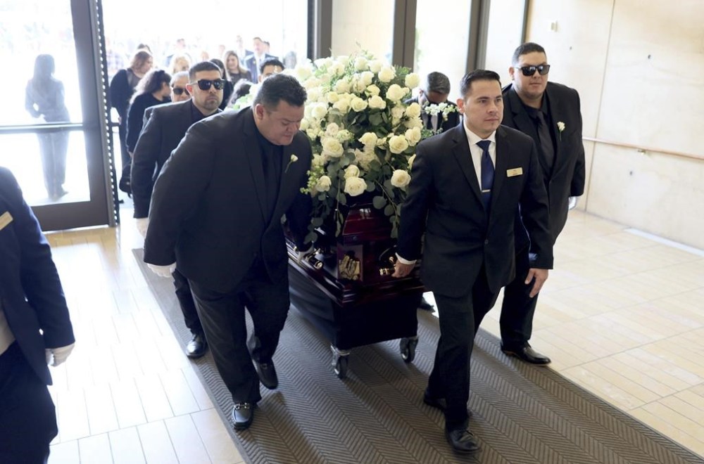 Fernando Valenzuela's sons, Fernando Valenzuela Jr., left, and Ricardo Valenzuela, far right, help guide Los Angeles Dodgers pitcher Fernando Valenzuela's casket into the Cathedral of Our Lady of the Angels for a public funeral mass in Los Angeles Wednesday, Nov. 6, 2024.(Robert Gauthier/Pool via AP)