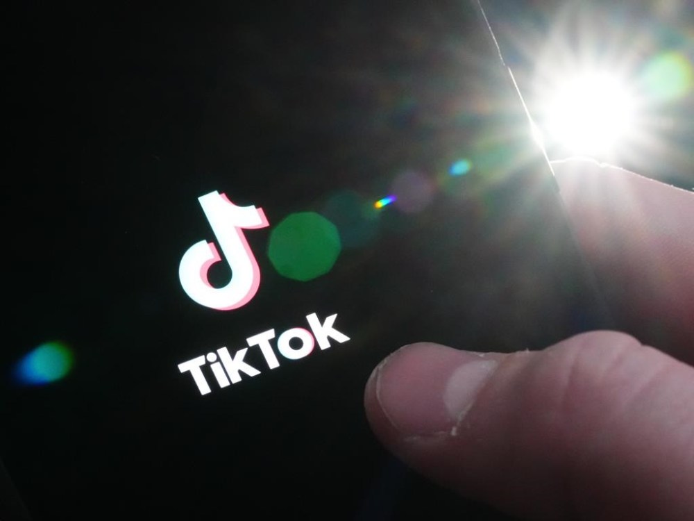 The TikTok startup page is displayed on an iPhone in Ottawa, Monday, Feb. 27, 2023. THE CANADIAN PRESS/Sean Kilpatrick
