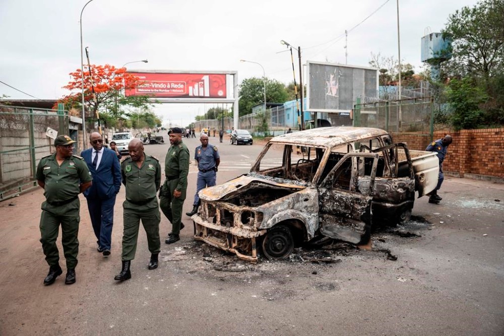 Border officials inspect a burnt-out Mozambican border patrol vehicle at the border crossing in Lebombo, South Africa, Thursday, Nov. 7, 2024. South Africa closed its border with Mozambique shortly after opening it on Thursday as post-election violence in the neighboring country escalated. (AP Photo)