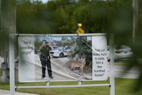 A road sign warns motorists not to speed in an area frequented by Key Deer, the smallest subspecies of the white-tailed deer that have thrived in the piney and marshy wetlands of the Florida Keys, Wednesday, Oct. 16, 2024, in Big Pine Key, Fla. (AP Photo/Lynne Sladky)