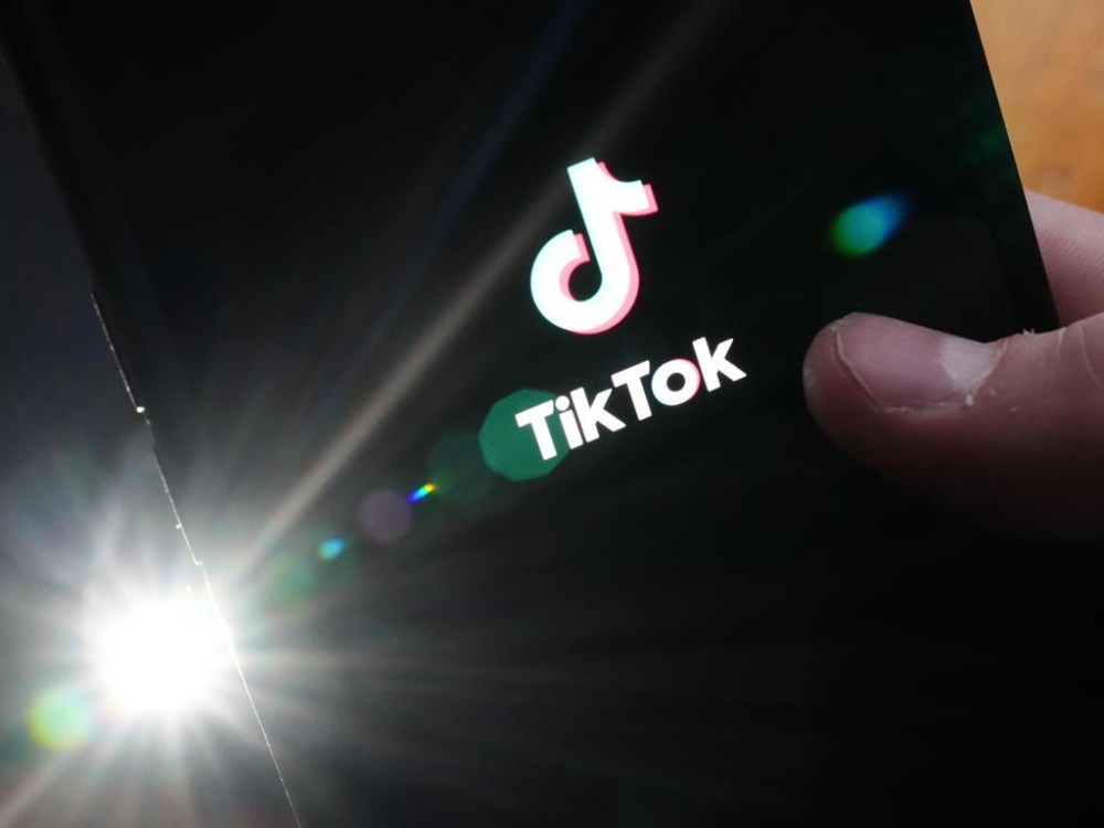 The TikTok startup page is displayed on an iPhone in Ottawa, Monday, Feb. 27, 2023. THE CANADIAN PRESS/Sean Kilpatrick