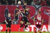 Olympiacos' Sergio Oliveira, left, jumps for the Baal among Rangers' Robin Proepper, centre and Connor Barron, right, during the Europa League opening phase soccer match between Olympiacos and Rangers at the Georgios Karaiskakis stadium at Athens' port of Piraeus, Greece, Thursday, Nov. 7, 2024. (AP Photo/Thanassis Stavrakis)