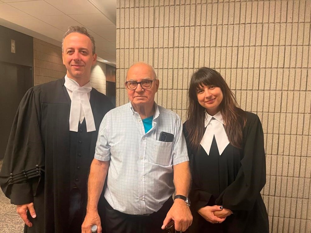 Claude Paquin (centre) is flanked by lawyers Nicholas St-Jacques and Julie Harinen at the Montreal courthouse on Wednesday after a judge overturned his conviction in connection with the 1978 murder of two people. THE CANADIAN PRESS/HO-Julie Harinen **MANDATORY CREDIT**