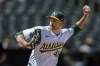 FILE - Oakland Athletics closing pitcher T.J. McFarland throws against the Baltimore Orioles during the ninth inning of a baseball game Saturday, July 6, 2024, in Oakland, Calif. Left-hander T.J. McFarland is remaining with the Athletics, agreeing Thursday, Nov. 7, 2025 to a $1.8 million, one-year contract. (AP Photo/John Hefti, File)