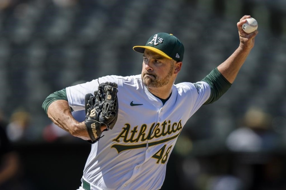 FILE - Oakland Athletics closing pitcher T.J. McFarland throws against the Baltimore Orioles during the ninth inning of a baseball game Saturday, July 6, 2024, in Oakland, Calif. Left-hander T.J. McFarland is remaining with the Athletics, agreeing Thursday, Nov. 7, 2025 to a $1.8 million, one-year contract. (AP Photo/John Hefti, File)