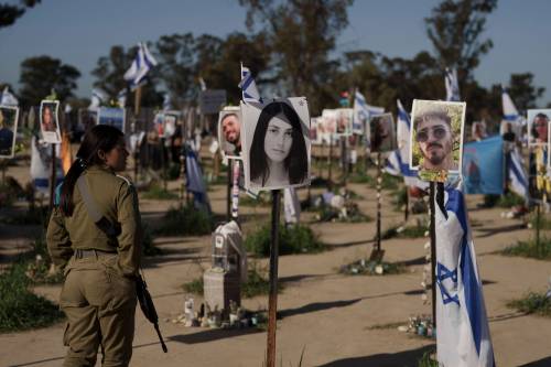 A woman, a member of the Israeli forces, visits the site where revellers were killed and kidnapped on Oct. 7 in a cross-border attack by Hamas militants at the Nova music festival near the kibbutz Reim, southern Israel, in March. (Leo Correa / The Associated Press files)
