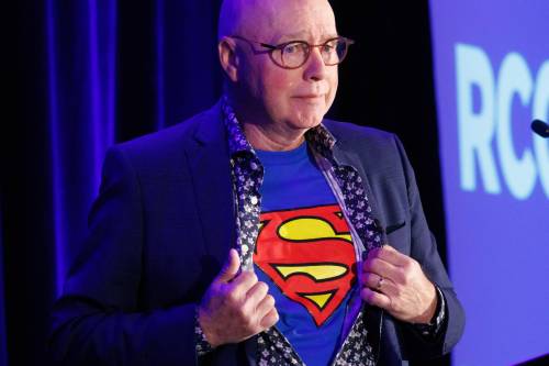 MIKE DEAL / FREE PRESS
                                Ray Wyant, former Chief Justice, Provincial Court of Manitoba, shows his Superman t-shirt underneath his shirt as he speaks to about 400 attendees at the Retail Crime Summit that was held at the RBC Convention Centre Friday.