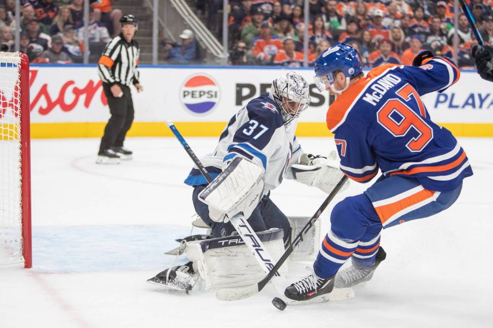 Amber Bracken / THE CANADIAN PRESS
Jets goalie Connor Hellebuyck stymies Oilers’ star centre Connor McDavid, one of his 30 saves in the Jets shutout victory.