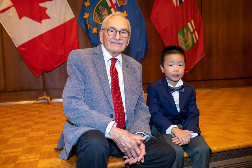 Choir alumnus Jim Shepherd with its youngest current member, Oakley Guo. (Brook Jones / Free Press)