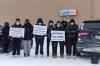 Daniel Crump / Free Press Files
                                Friends of John Lloyd Barrion hold signs during a vigil in his honour on February 19, 2022 at the Travelodge on Notre Dame Ave. The 19-year-old was killed four days earlier while working at the beer vendor attached to hotel.