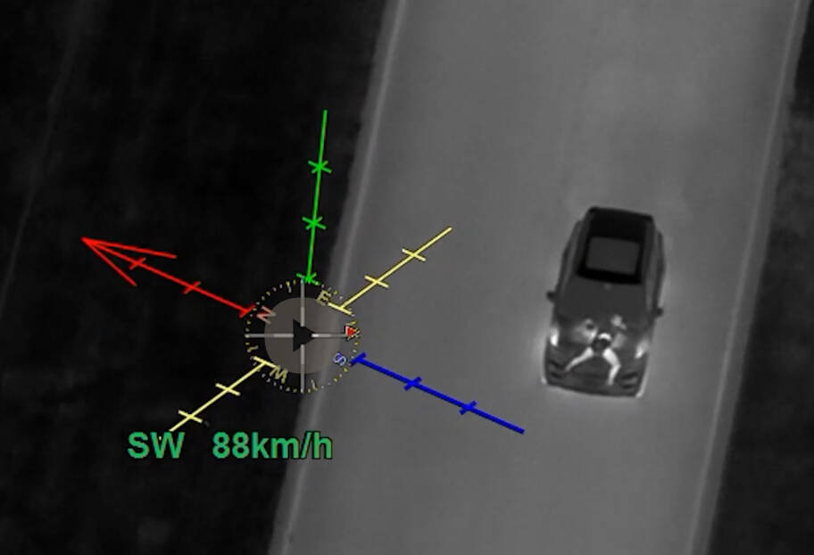 An image from video obtained by police shows a person stretched out on the hood of a vehicle as it travels at speeds higher than 120 km/h in a 50 km/h zone in an industrial park. (Supplied)