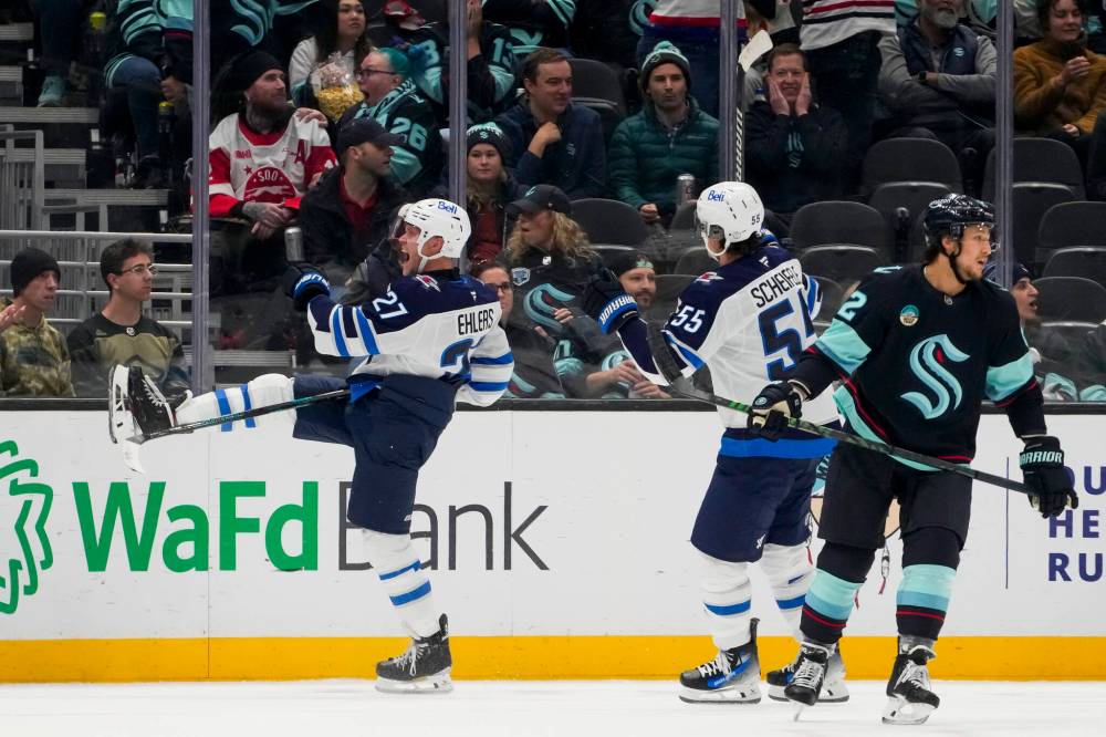 Lindsey Wasson / The Associated Press
Winnipeg Jets winger Nikolaj Ehlers, left, celebrates his game-winning goal in front of teammate Mark Scheifele during overtime Thursday, in Seattle. The Jets bested the Seattle Kraken 4-3 for their seventh-straight win to start the regular season.