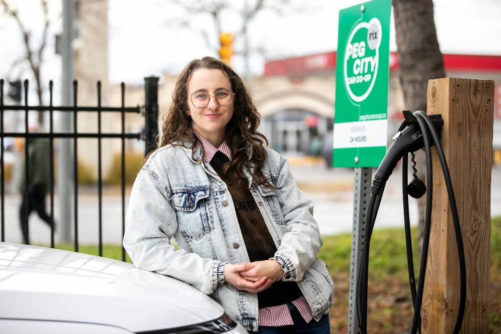 MIKAELA MACKENZIE / FREE PRESS
Michelle Panting and one of Peg City Car Co-op’s two new EVs (and Level 2 charging station) in Winnipeg. ‘We try to find partners for new programs like this and ACU, as well as the two housing co-ops, are a good example of that,’ she says.