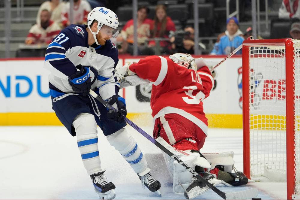 Carlos Osorio / The Associated Press
Kyle Connor dangles Red Wings goaltender Alex Lyon to score Wednesday during first-period action in Detroit.