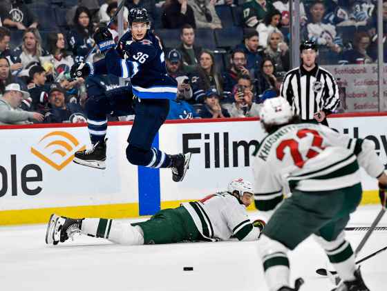 Winnipeg Jets' Morgan Barron (36) leaps over Minnesota Wild's Jon Merrill (4) during the Oct. 13 game in Winnipeg. (Fred Greenslade / The Canadian Press files)