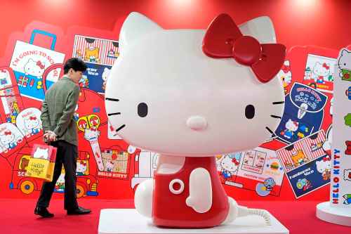 A visitor looks at giant Hello Kitty display at the exhibition 