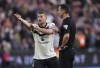 Manchester United's Matthijs de Ligt (left) protests to referee David Coote after he awards a penalty to West Ham United during the English Premier League soccer match between West Ham United and Manchester United at the London Stadium in London, Sunday, Oct. 27, 2024. (John Walton/PA via AP)