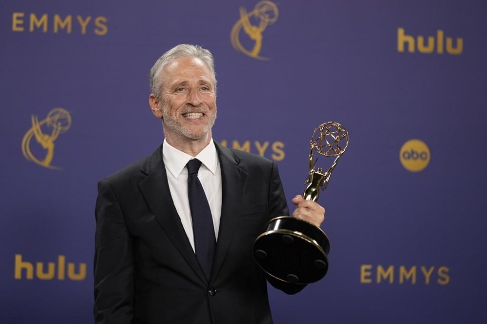 FILE - Jon Stewart poses in the press room with the award for outstanding talk series for