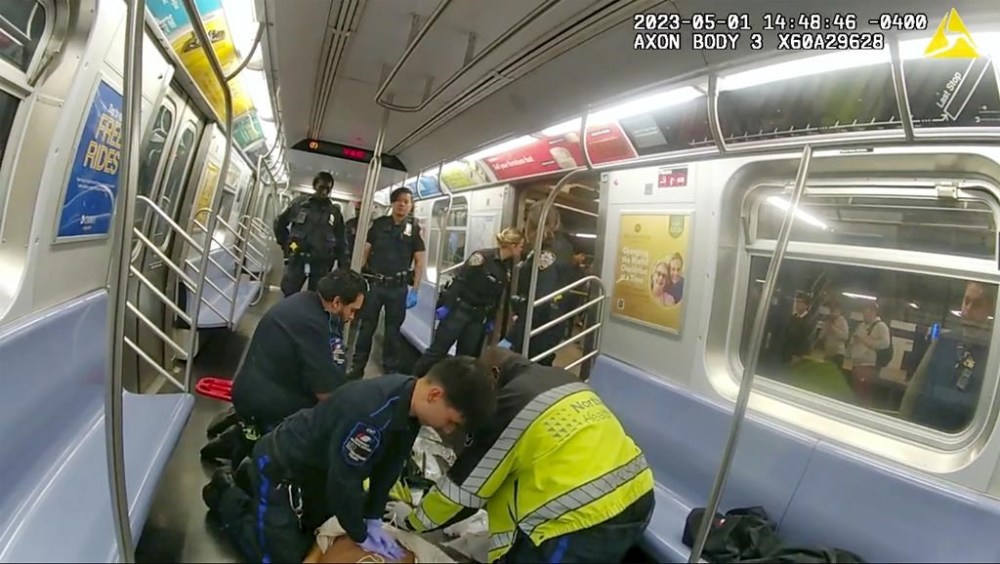 In this image from body camera video provided by New York City Police Department, emergency medical personnel in a New York City subway car attempt to revive Jordan Neely after he was placed in a chokehold by Daniel Penny on May 5, 2023. (New York City Police Department via AP)