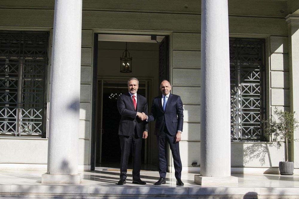 Greek Foreign Minister George Gerapetritis, right, welcomes his Turkish counterpart Hakan Fidan before their meeting in Athens, Greece, Friday, Nov. 8, 2024. (AP Photo/Thanassis Stavrakis)