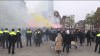 In this image taken from video, police stand guard as Maccabi Tel Aviv supporters light flares at the Dam square, in Amsterdam, the Netherlands, Thursday, Nov. 7, 2024. (AP Photo InterVision)