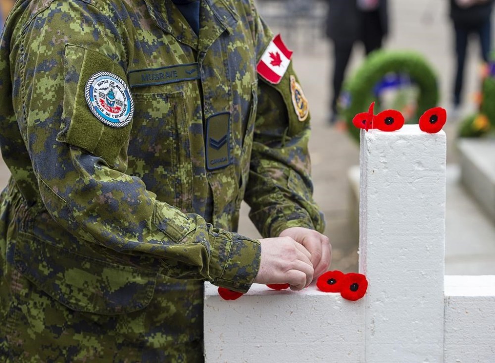 A school in the Halifax area has backed away from its request that service members not wear military uniforms to the school’s Remembrance Day ceremony. Poppies are placed on a cross at the end of Remembrance Day ceremonies at the Grand Parade in Halifax on Wednesday, Nov. 11, 2020. THE CANADIAN PRESS/Andrew Vaughan