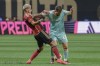 Inter Miami forward Lionel Messi (10) attempts to maintain the ball during the first half of an MLS soccer match against Atlanta United, Saturday, Nov. 2, 2024, in Atlanta. (AP Photo/Jason Allen)
