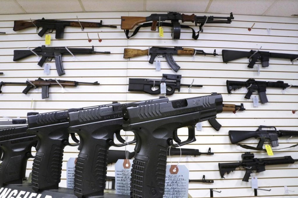 FILE - Assault style weapons and hand guns are displayed for sale at Capitol City Arms Supply on Jan. 16, 2013, in Springfield, Ill. (AP Photo/Seth Perlman, File)