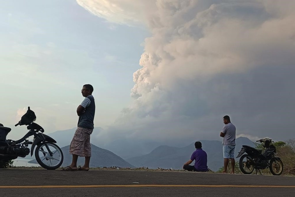 Residents watch as Mount Lewotobi Laki Laki volcano spews volcanic materials during an eruption in East Flores, Indonesia Saturday, Nov, 9, 2024. (AP Photo)