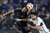 Los Angeles FC's Maxime Chanot, left, vies for the ball against Vancouver Whitecaps' Brian White, right, during the first half of a first-round MLS Cup playoffs soccer match, Friday, Nov. 8, 2024, in Los Angeles. (AP Photo/Etienne Laurent)