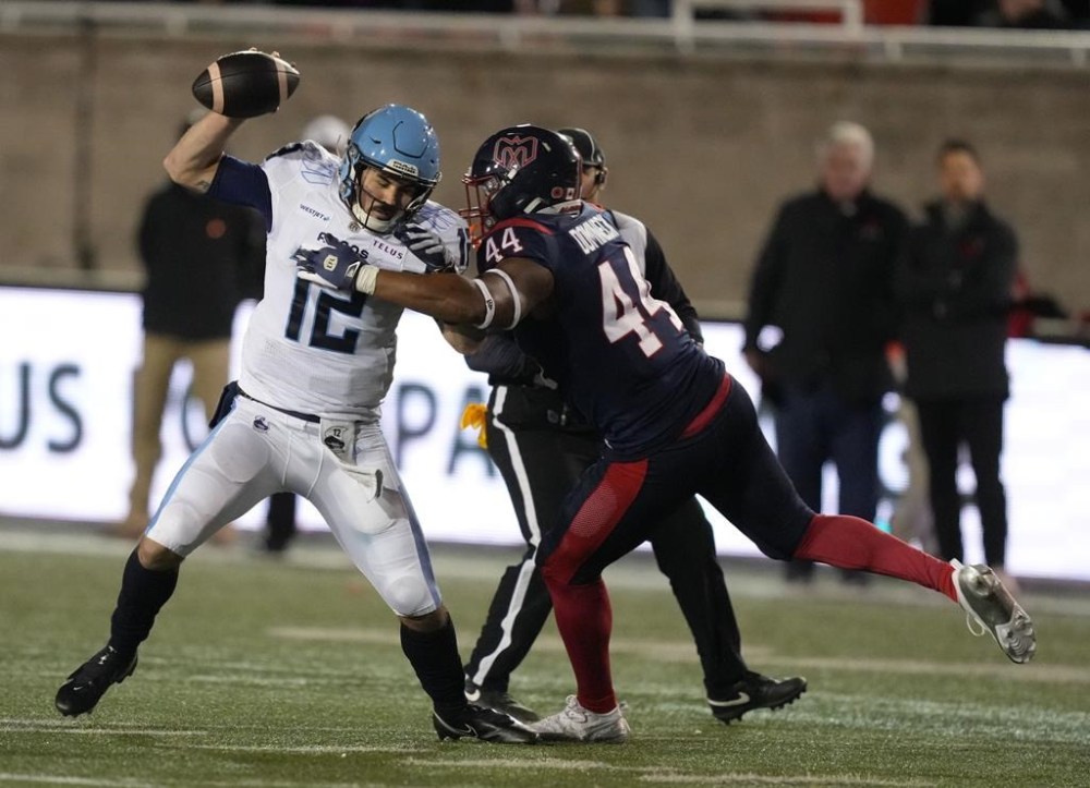 Toronto Argonauts quarterback Chad Kelly (12) is tackled by Montreal Alouettes defensive end Jordan Domineck (44) during third quarter CFL Eastern Conference Final football action Saturday, November 9, 2024 in Montreal. THE CANADIAN PRESS/Christinne Muschi