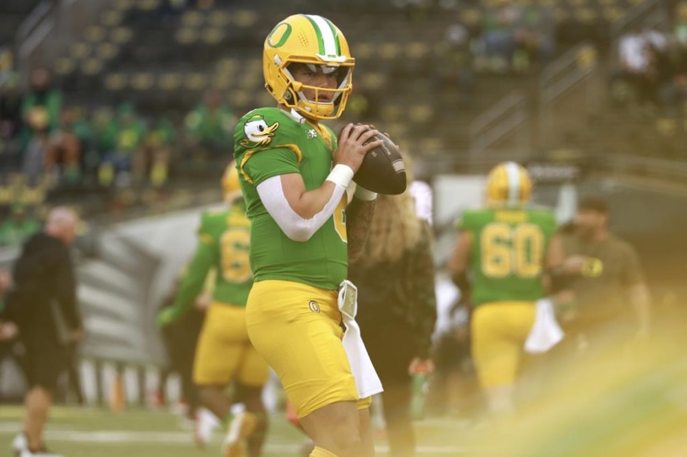 Oregon quarterback Dillon Gabriel (8) warms up before an NCAA college football game, Saturday, Nov. 9, 2024, in Eugene, Ore. (AP Photo/Lydia Ely)