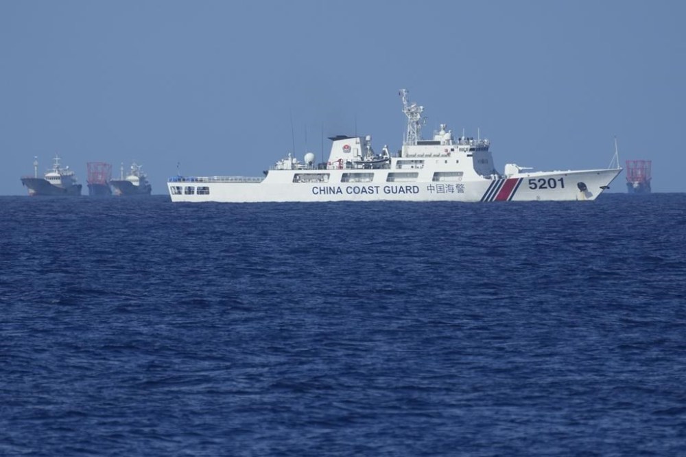 A Chinese coast guard vessel stays beside suspected Chinese militia ships near Thitu island, locally called Pag-asa island on Wednesday, Nov. 6, 2024 ahead of a Philippine military multi-service joint exercise at the disputed South China Sea, Philippines. (AP Photo/Aaron Favila)