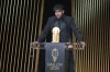 Barcelona's Spanish player Lamine Yamal receives the Kopa Trophy during the 68th Ballon d'Or (Golden Ball) award ceremony at Theatre du Chatelet in Paris, Monday, Oct. 28, 2024. (AP Photo/Michel Euler)