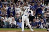 Los Angeles Dodgers' Shohei Ohtani hits RBI-single against the New York Mets during the sixth inning in Game 6 of a baseball NL Championship Series, Sunday, Oct. 20, 2024, in Los Angeles. (AP Photo/Mark J. Terrill)