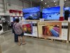 FILE - Shoppers consider big-screen televisions on display in a Costco warehouse Tuesday, Oct. 22, 2024, in Sheridan, Colo. (AP Photo/David Zalubowski, File)